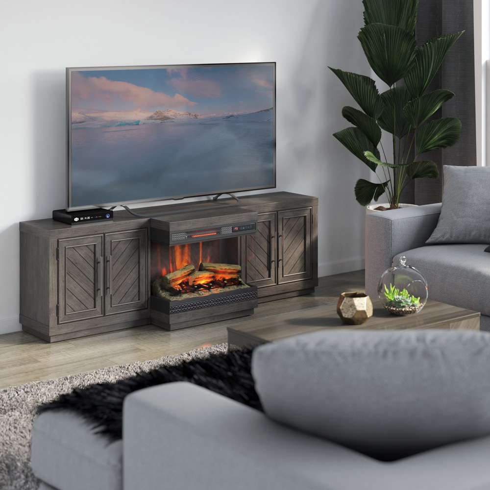 A tv stand with a panoramic electric fireplace built in sits in a cozy room full of neutral earth tones.