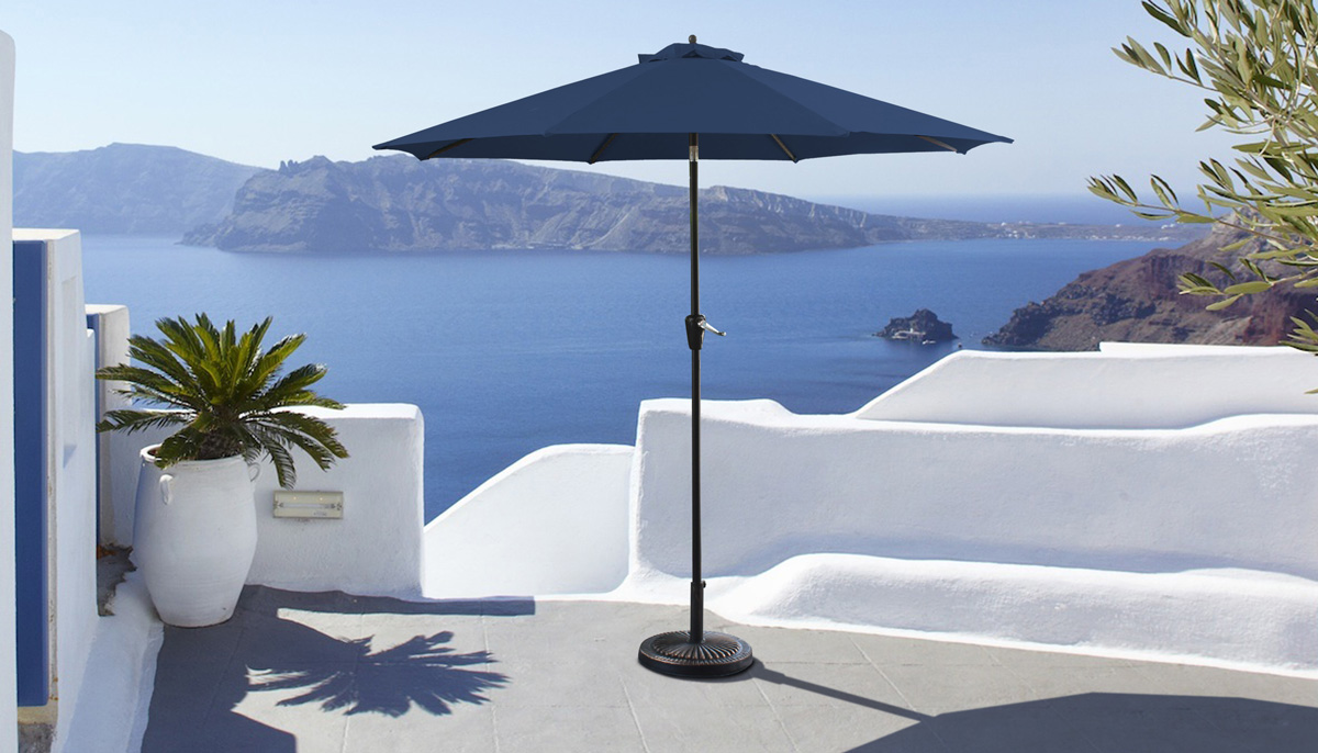 A patio furniture umbrella with a black pole and blue shade sits outside on a patio.