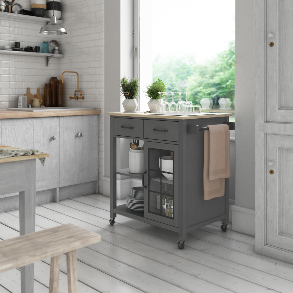 a gray kitchen cart perfect for holding wine glasses or mother's Day gifts, in a well-lit, rustic kitchen in whites and grays.